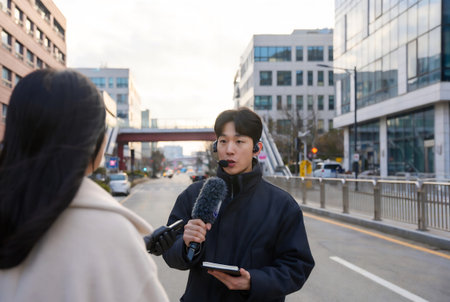 Unidentified Japanese woman with a microphone in front of a man in Tokyo.の素材