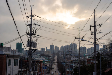 High-voltage power lines in the city at sunset, Japanの素材