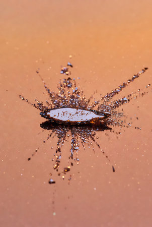 Water drop splashing on a brown background. Water drops on the glass.の素材