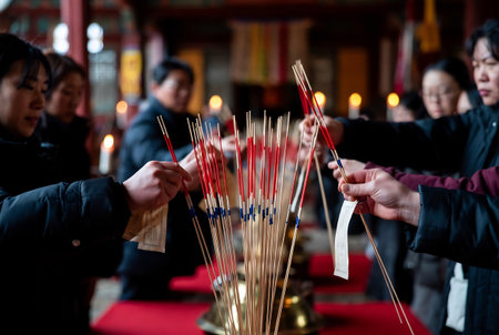 Chinese people pray with incense sticks in the traditional Chinese temple.の素材