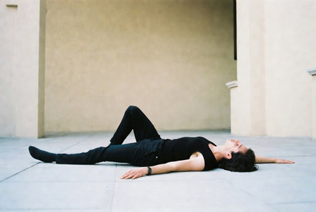 young beautiful brunette woman in black posing on the street, lifestyle people conceptの素材