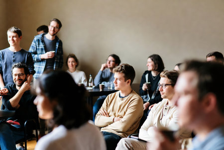 Group of young people sitting and listening to the lecturer at the conference hallの素材