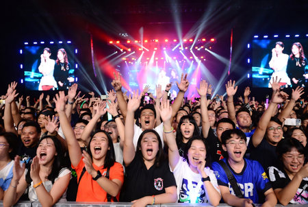 Unidentified people singing and dancing on the stage during the concert of Thai pop-techno band in Bangkok, Thailand.の素材