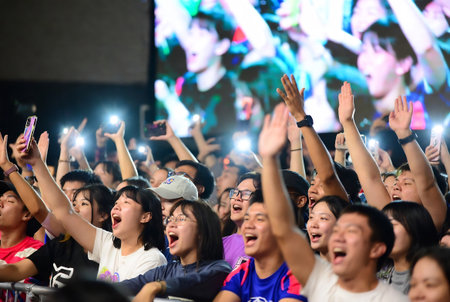 Unidentified people enjoy the live music on the stage.の素材