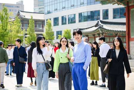 Group of asian people in traditional clothes walking in the street of Koreaの素材