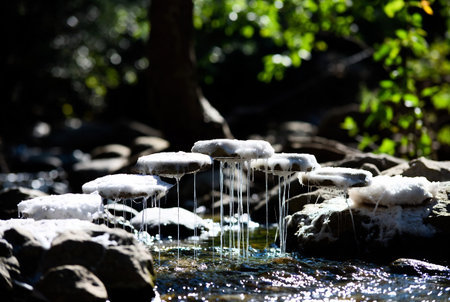 Small waterfall in the forest. Selective focus. Shallow depth of field.の素材
