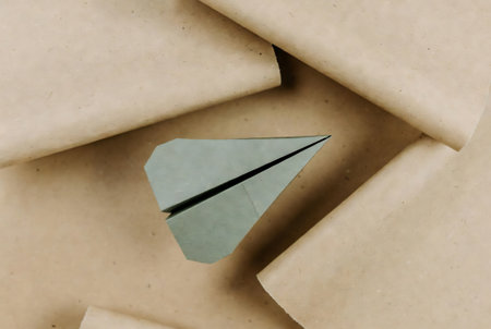 Paper plane on brown paper background. Paper airplane as a symbol of success.の素材