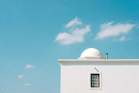 White building with blue sky and white cloud background, with copy spaceの素材