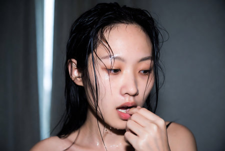 Portrait of beautiful young asian woman taking a shower in the bathroomの素材