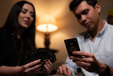 Young couple playing poker in a casino. Focus on black cards.の素材