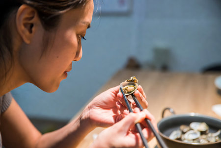 Asian woman cooking Japanese food in the kitchen at home, close upの素材