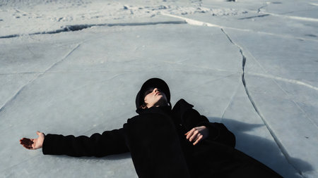 Young woman in a black coat on the ice of Lake Baikalの素材