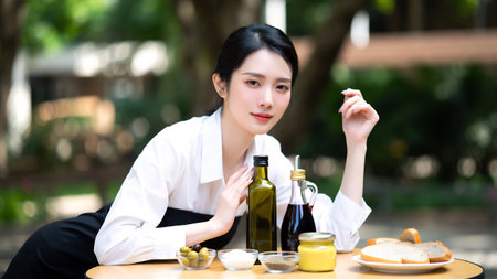 Young asian woman sitting at a table in a coffee shop.の素材