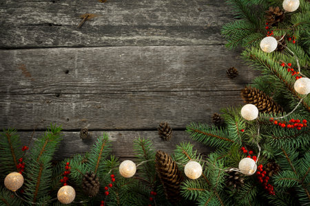Round Christmas Holiday Evergreen Pine Branches and Red Berries Over Wood Background. Christmas...