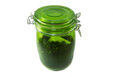 Coffee beans in glass bottles white backgroundの写真素材