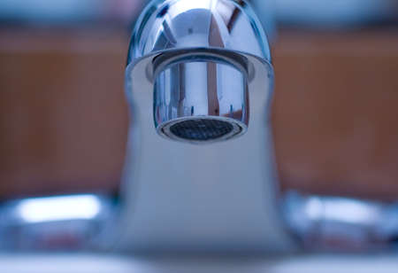 Close up on a shiny water faucetの写真素材