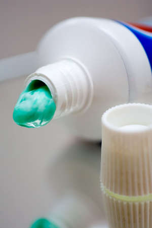 Close view at an opened toothpaste tube with some paste squeezed outの写真素材
