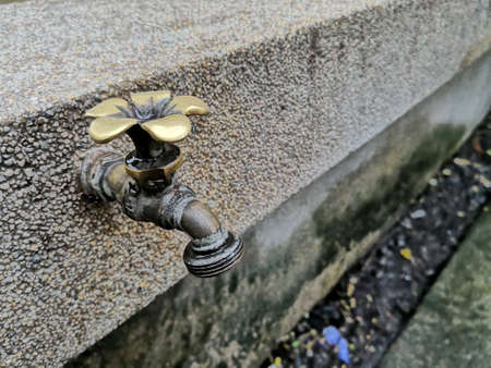 Golden brass tap in the city parkの素材
