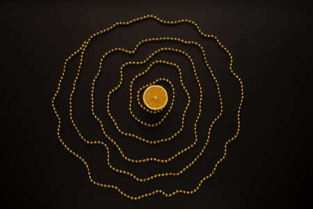 Not a perfect circle made of gold beads,with lemon in the middle. Minimal flat lay. Black...
