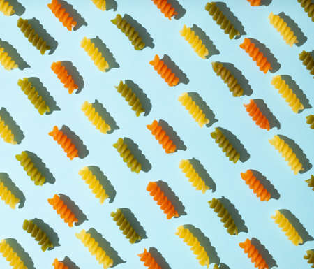 Creative pattern made of spiral macaroni on a pastel blue background.の写真素材