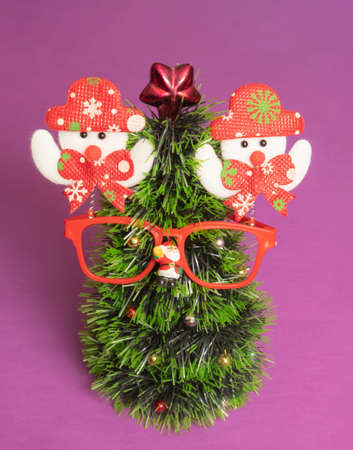 Fun Christmas tree with glasses. Minimal holiday concept on velvet violet backgrounds.の写真素材