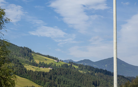 Eben im Pongau, Salzburg - Austria. View reveals picturesque alpine plateau with beautiful houses, lush trees, and verdant meadows.の写真素材