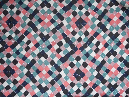 Colorful patterned fabric table on retro background 