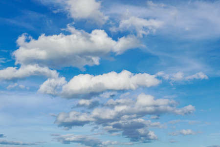 Clouds float in the sky with a blue background.