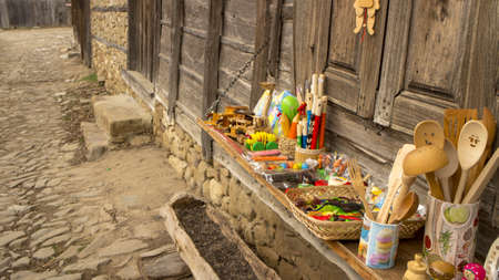 Zheravna/Bulgaria - March 3, 2020: Historic wooden house from the 19th century selling colorful items for tourists. The items are traditional for bulgarian culture. Zheravna is ancient village.のeditorial素材