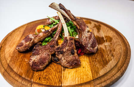 Chopped lamb ribs with potatoes peppers and rocket