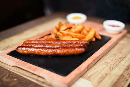 restaurant plate served with sausages and potatoesの写真素材