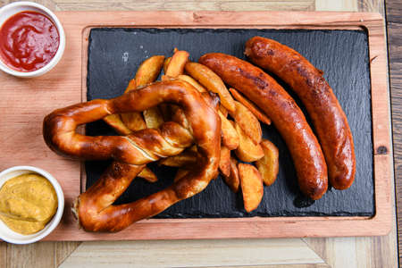 restaurant plate served with sausages and potatoesの写真素材