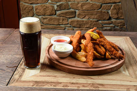 Crispy chicken and potatoes fried with spicesの写真素材