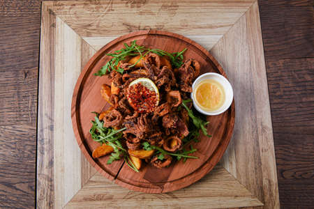 restaurant plate served with squid rings and potatoesの写真素材
