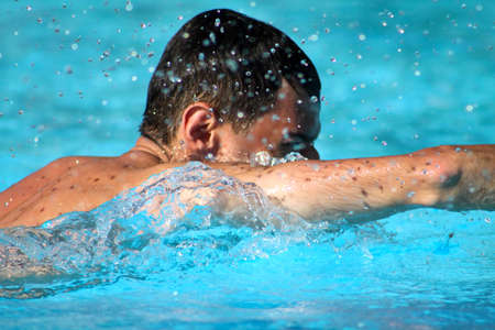 man swim in blue waterの写真素材