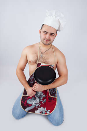 man in cook cap with frying panの写真素材
