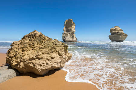 Gog and Magog are two giant limestone stacks offshore from the Gibson Steps on the Great Ocean Road outside Port Campbell in Victoria, Australiaの写真素材