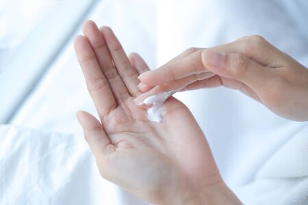 Woman applying moisturizing cream, lotion on hands, beauty concept.の写真素材
