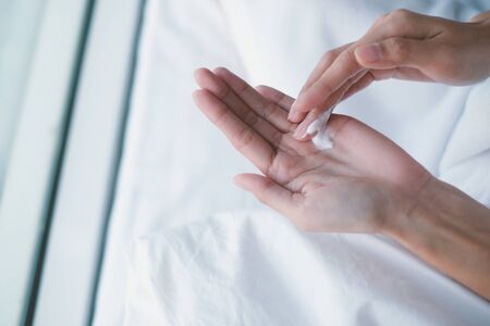 Woman applying moisturizing cream, lotion on hands, beauty concept.の写真素材