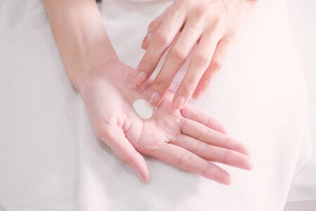 Woman applying moisturizing cream, lotion on hands, Top View, beauty concept.