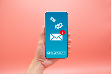 Beautiful hand working on a smartphone with email icons, Concept of sending message wireless using smartphone, copy space for design.の写真素材