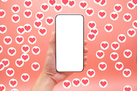 Valentine day concept, Woman holding smartphone with blank screen and heart icon.