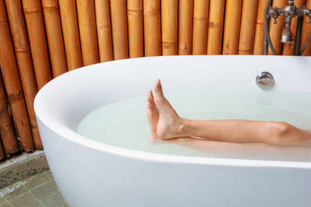 Women's feet she was bathing in a a bathtub with happinessの写真素材