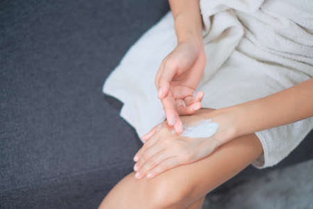 Woman applying natural cream, Woman moisturizing her hand with cosmetic cream, Spa and Manicure concept.の写真素材