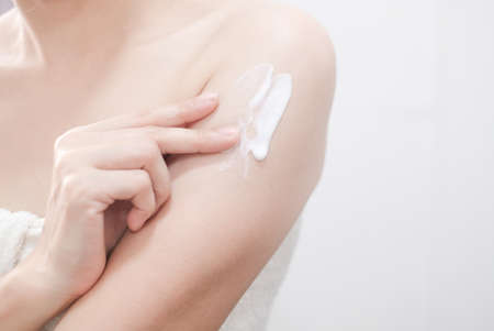 Woman applying natural cream, Woman moisturizing her arm with cosmetic cream, Spa and Manicure concept.の写真素材