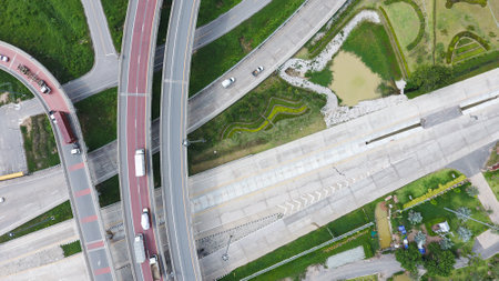 Aerial view of highway and overpass in city on a sunny day.