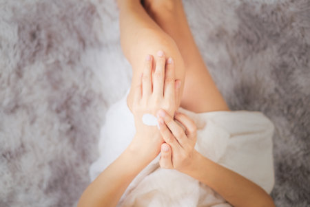 Woman applying natural cream, Woman moisturizing her hand with cosmetic cream, Spa and Manicure concept.の写真素材