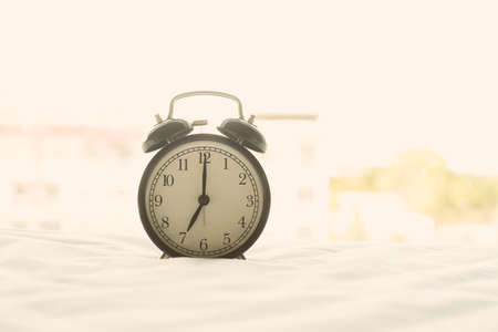 Alarm clock on blur background with copy space for you design.の写真素材