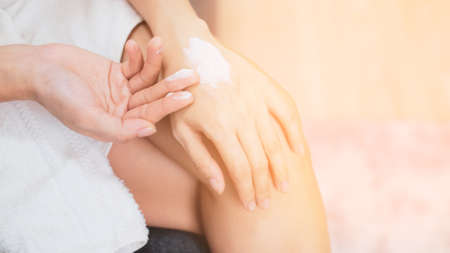 Woman applying natural cream, Woman moisturizing her hand with cosmetic cream, Spa and Manicure concept.の写真素材