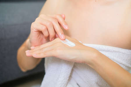 Woman applying natural cream, Woman moisturizing her hand with cosmetic cream, Spa and Manicure concept.の写真素材